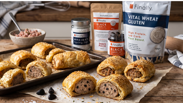 Golden, sesame-topped black garlic and herb sausage rolls beside Finally. Black Garlic, Ancient Spring Salt and Vital Wheat Gluten.