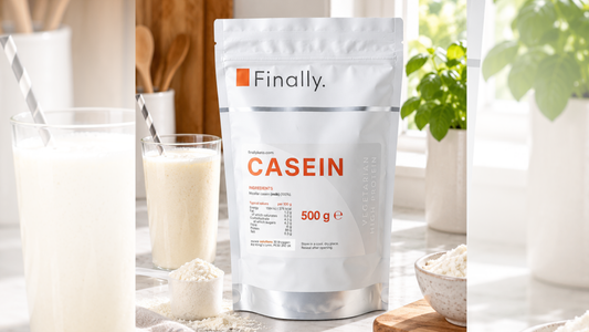 Finally. Casein 500g pouch beside a glass of creamy drink, a scoop and a bowl of protein powder on a kitchen counter.
