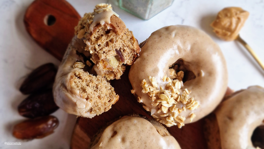 Gluten-free date and coffee doughnuts topped with nut butter glaze and granola, made with Finally. Soft Brown Keto Sugar
