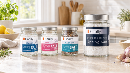 Finally. coarse, fine and black garlic spring salt jars beside a larger Ancient Spring Salt jar on a kitchen worktop.