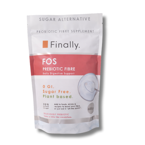 A white 600g stand-up pouch of Finally brand "FOS PREBIOTIC FIBRE" sugar alternative, isolated against a transparent checkerboard background. The pack features a broad, dusty rose-pink band with white text reading "FOS PREBIOTIC FIBRE", along with product details describing it as a "PROBIOTIC FIBRE SUPPLEMENT" that is "0 GI. Sugar Free. Plant based." and "33% as sweet as sugar."