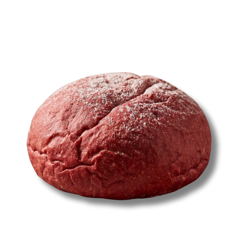 A product shot of a single, round Finally brand "Pinketo Bread" bun, isolated on a transparent checkered background. The bun features a distinct, vibrant red-pink colour and a soft, textured crust that is lightly dusted with white flour across the top.